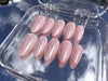 Aurora Pink pink glazed almond press on nails in sunlight