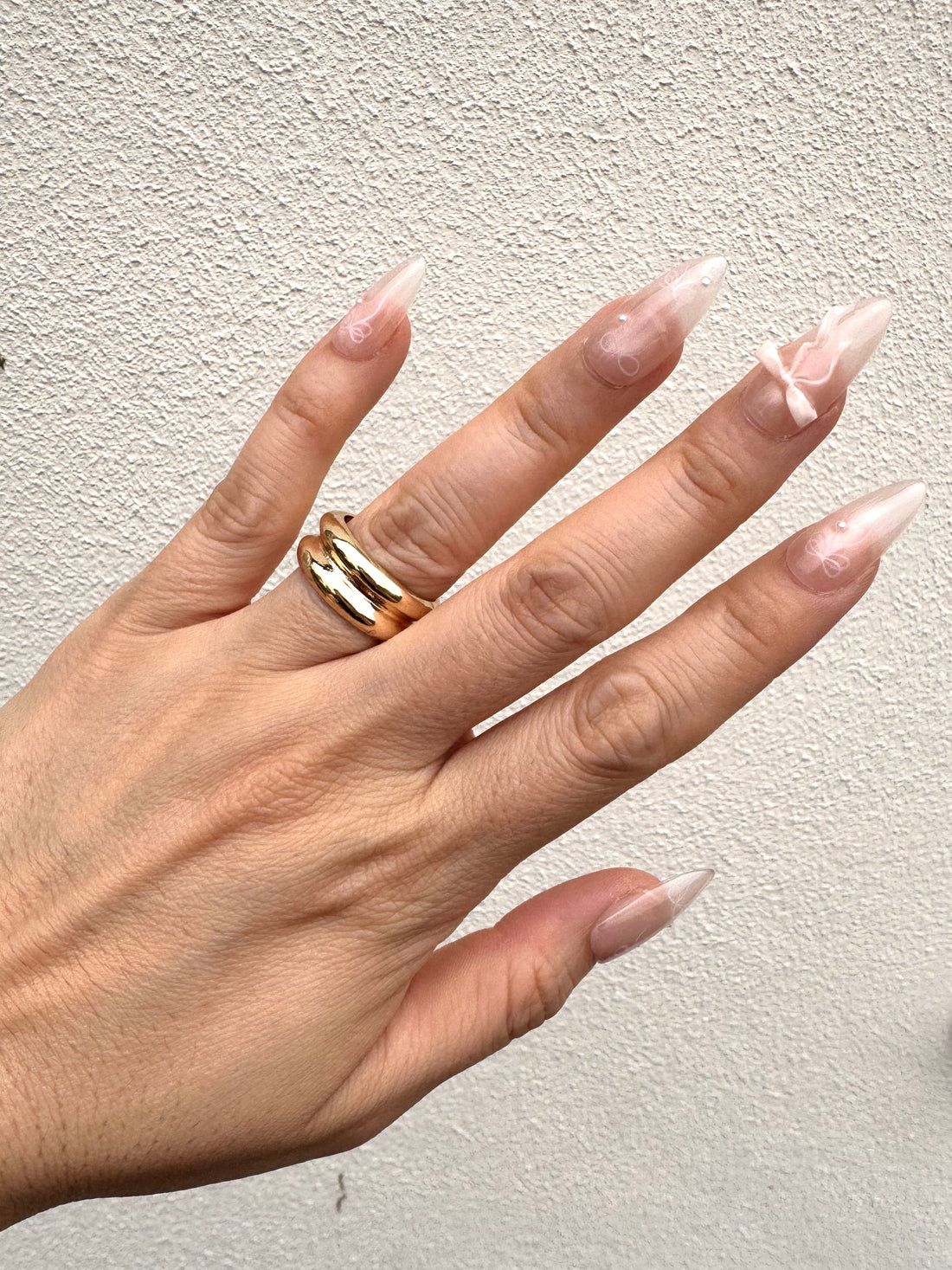 Blushing Bow Medium Almond press-on nails with ribbon and pearl details