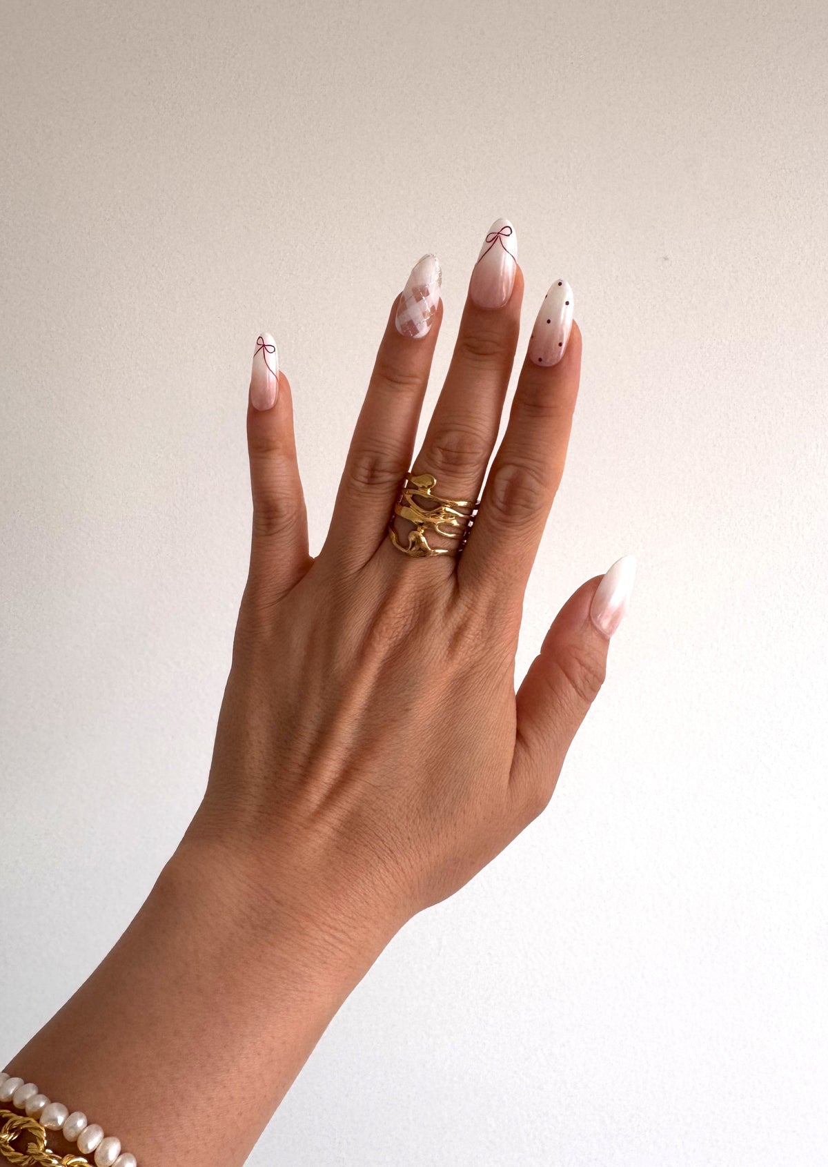 Coquette Berry Medium Oval press-on nails worn on hand