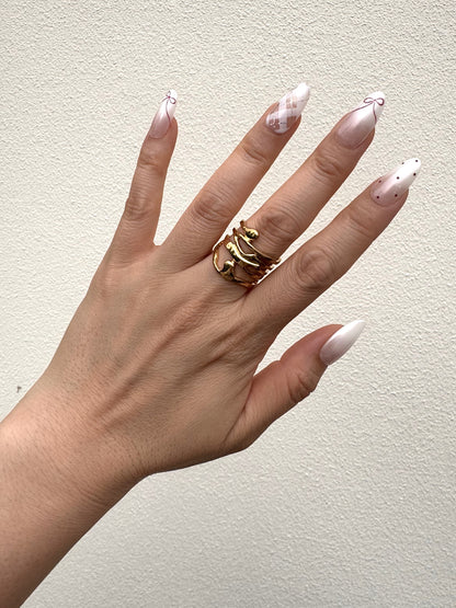 Coquette Berry pearly white and berry red Medium Oval press-on nails in natural light