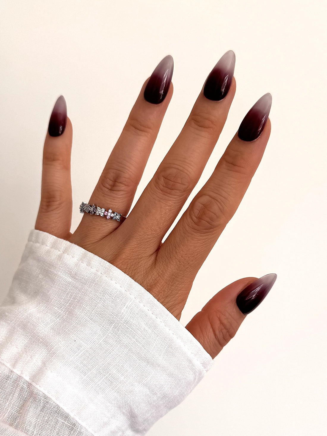 Cherry Mocha burgundy ombre Medium Almond press-on nails worn on hand