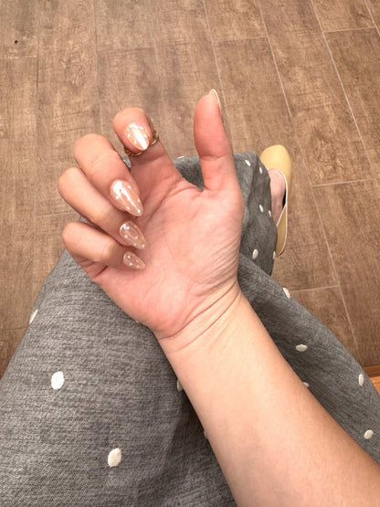 Glazed Dotty short almond press on nails worn on hand