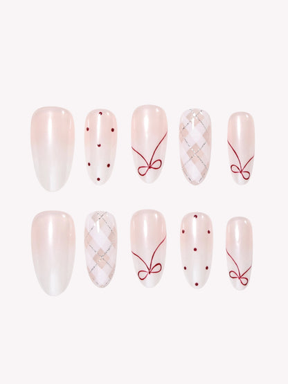 Coquette Berry pearly white Medium Oval press-on nails with berry red bows and argyle details