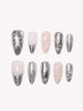 Close-up of Chrome Ribbon silver bow press-on nails
