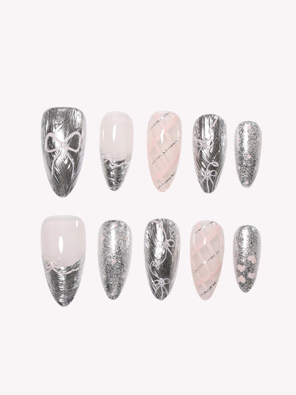 Close-up of Chrome Ribbon silver bow press-on nails