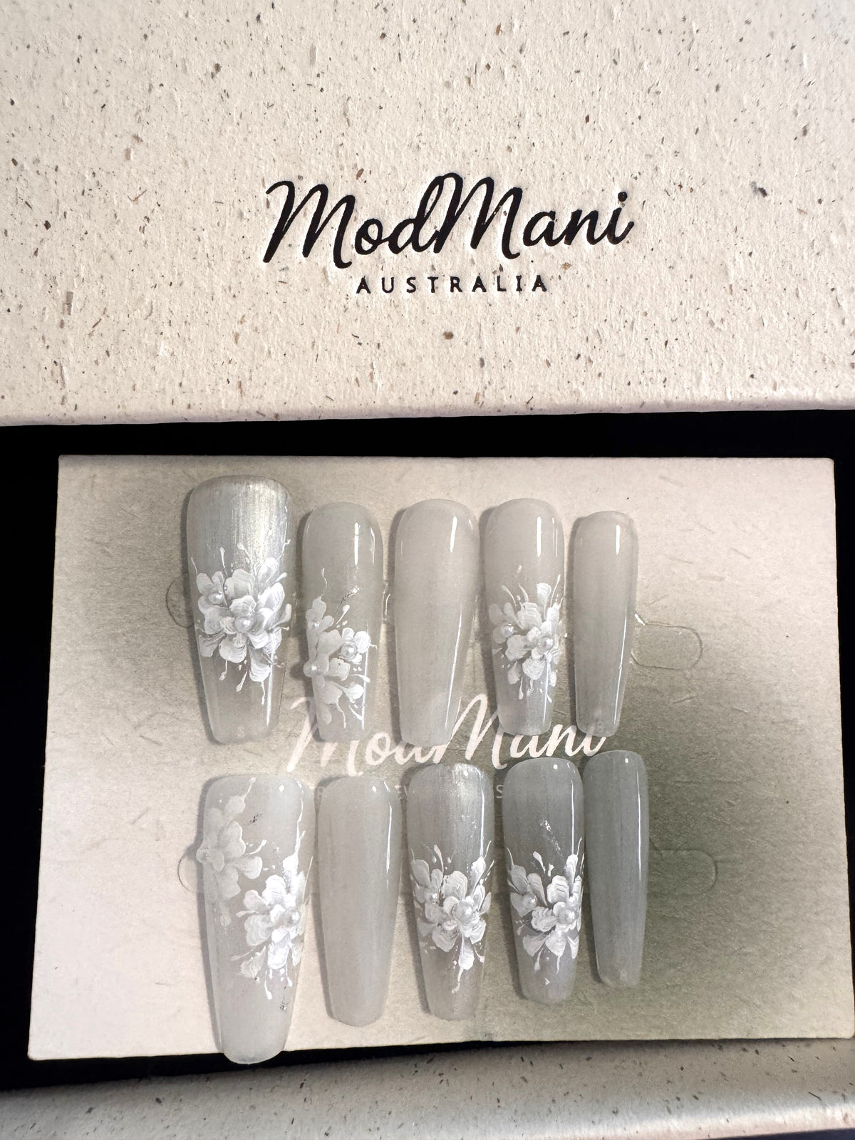 Pearl Bloom hand-painted floral press-on nails in premium ModMani presentation box