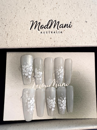 Pearl Bloom hand-painted floral press-on nails in premium ModMani presentation box