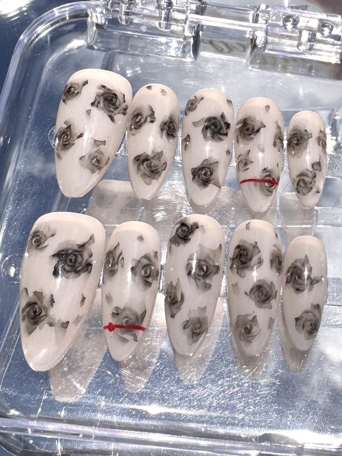 Close-up of individually hand-painted black roses on Noir Rose press-on nails
